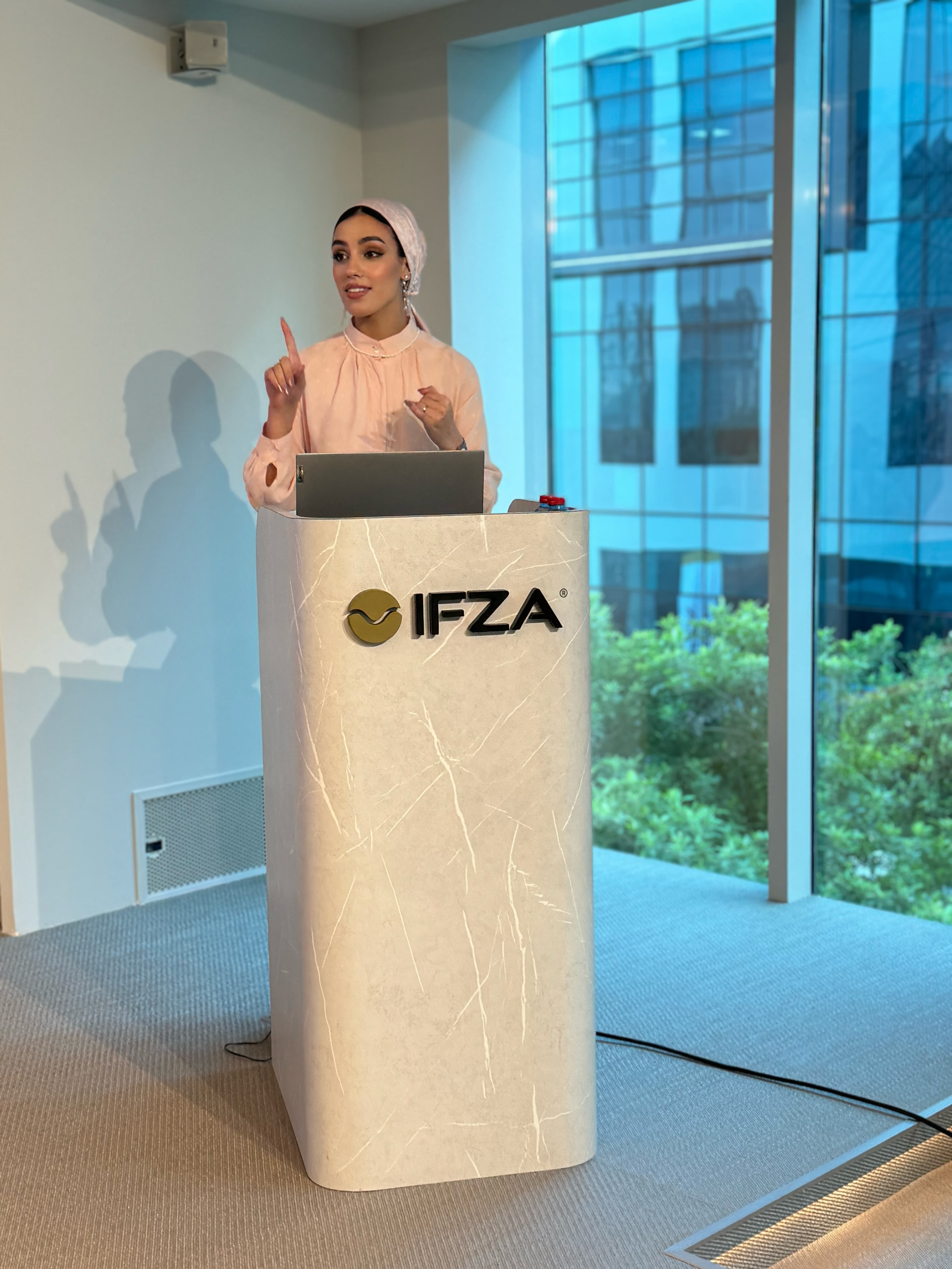 ISHRAQ BRAHMI delivering a presentation at an IFZA lectern